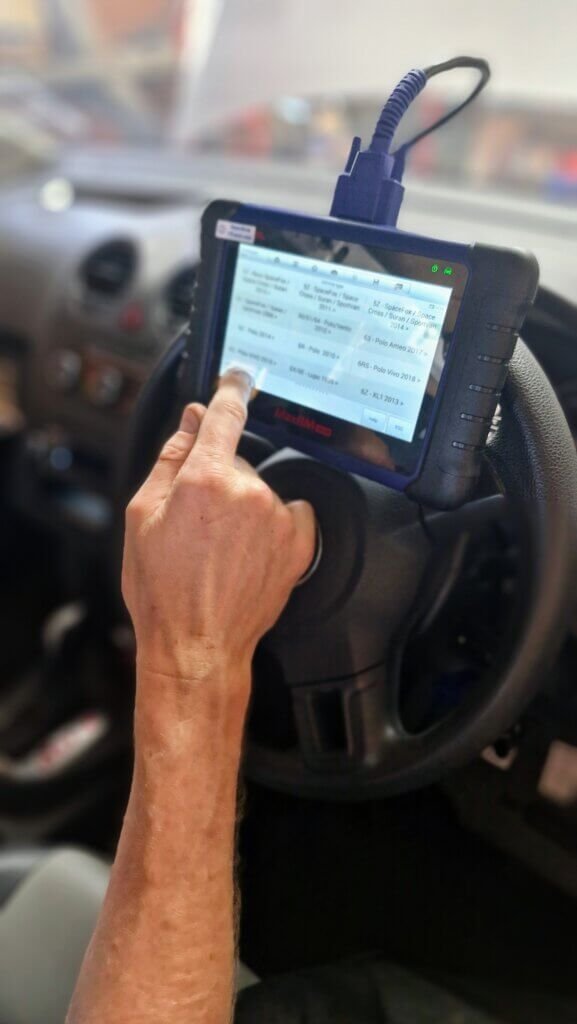 A Driveology technician uses a scantool to access the onboard computer network of a vehicle.